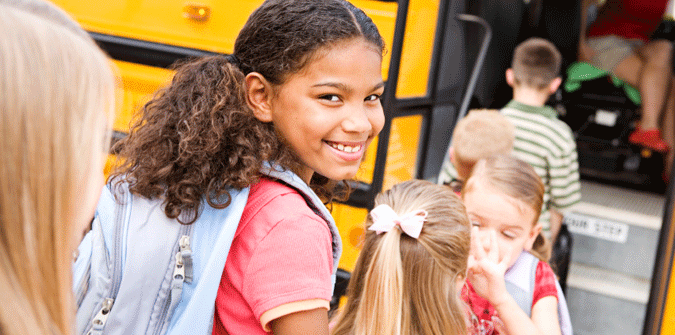 girl boarding school bus